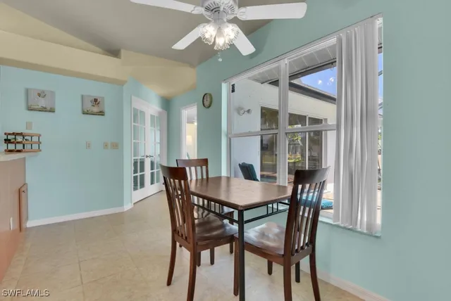a view of a dining room with furniture and a chandelier fan