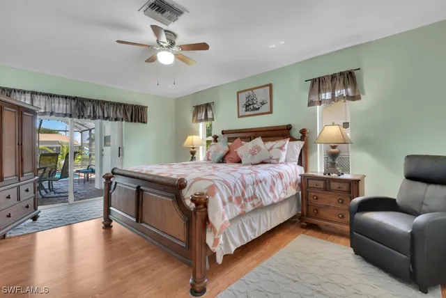 a bedroom with a large bed couch and a window