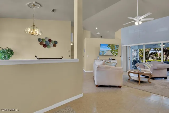a view of a bedroom with furniture and chandelier