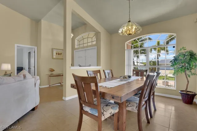 a view of a dining room with furniture and chandelier