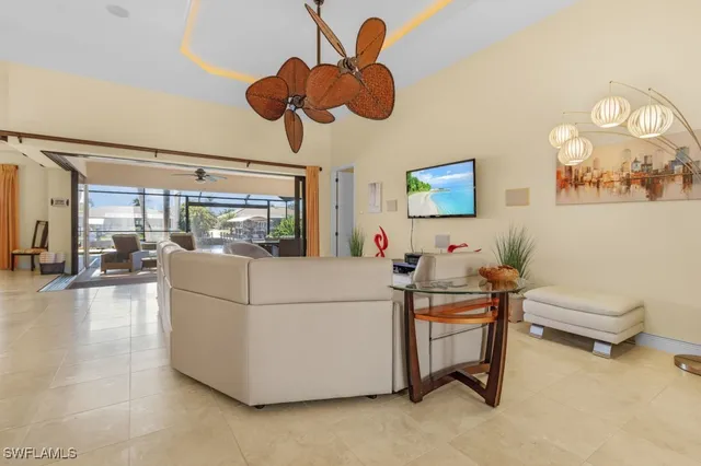 a living room with couches a dining table and chairs with outer view