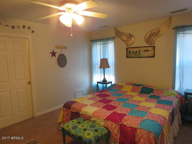 5735 Debbie Lane Rimrock, AZ 86335 - Photo 6 of 23 a bedroom with a bed and a chandelier