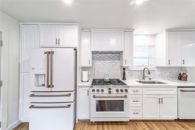 a kitchen with appliances cabinets and a counter top space