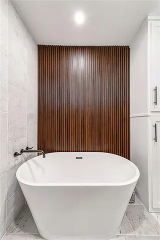 a bathroom with a bathtub and shower