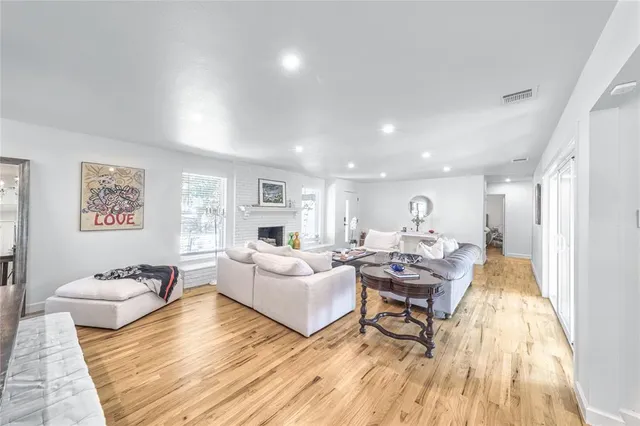 a living room with fireplace furniture and a wooden floor