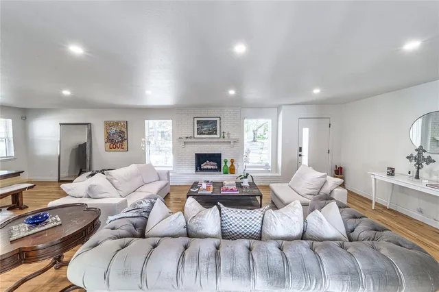a living room with furniture fireplace and a window
