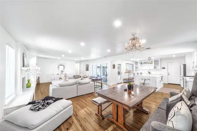 a living room with furniture kitchen view and a dining table