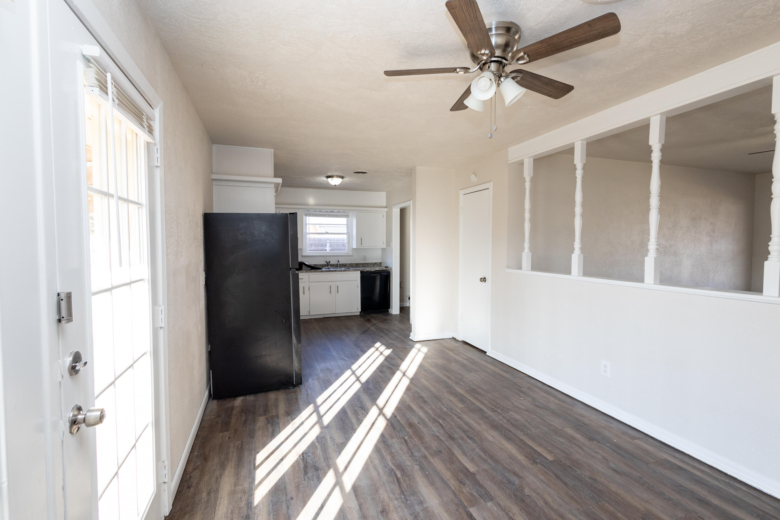 606 Bangor Avenue Lubbock, TX 79416 - Photo 11 of 26 a view of a kitchen with a refrigerator a ceiling fan and wooden floor