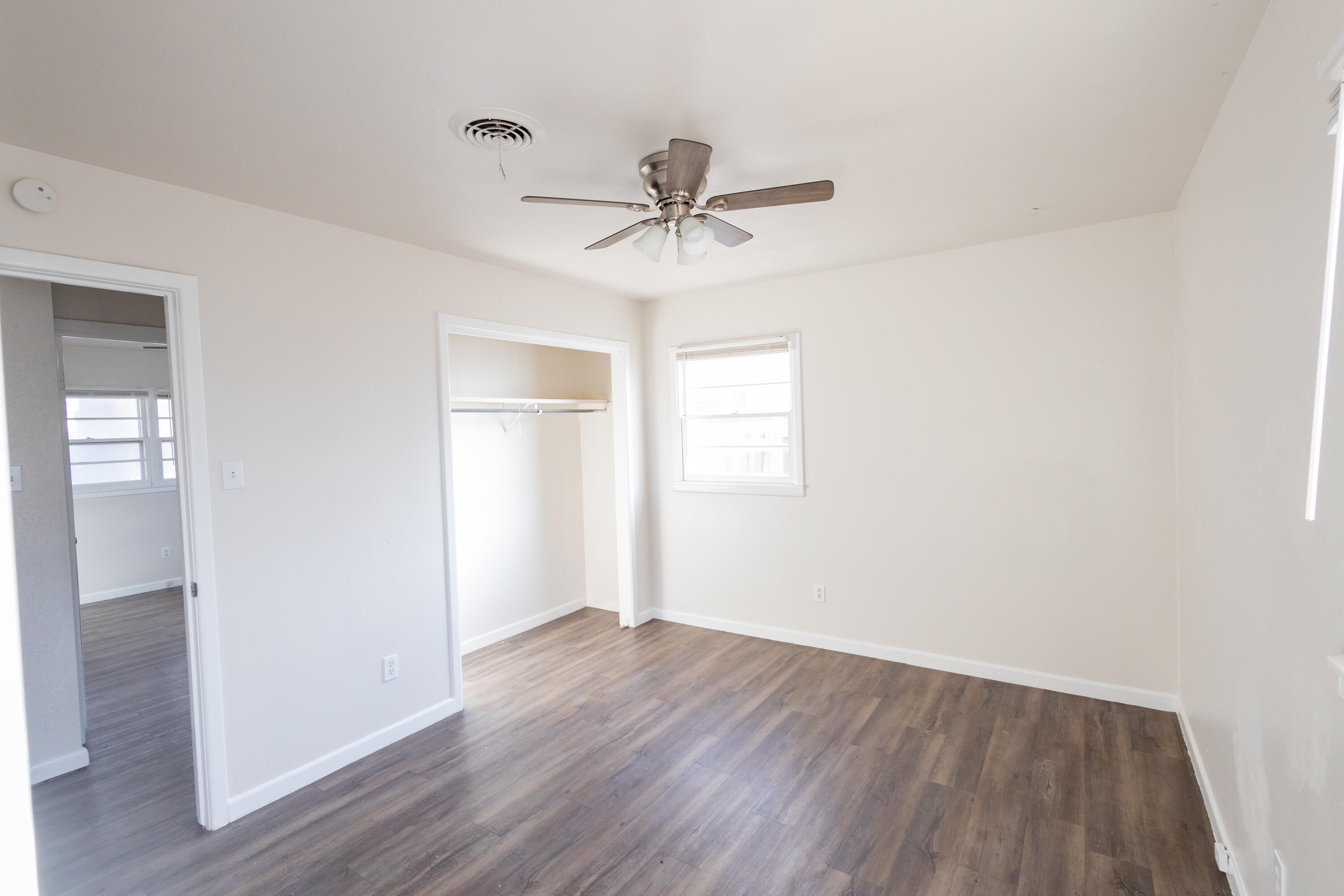 606 Bangor Avenue Lubbock, TX 79416 - Photo 14 of 26 wooden floor in an empty room with a window