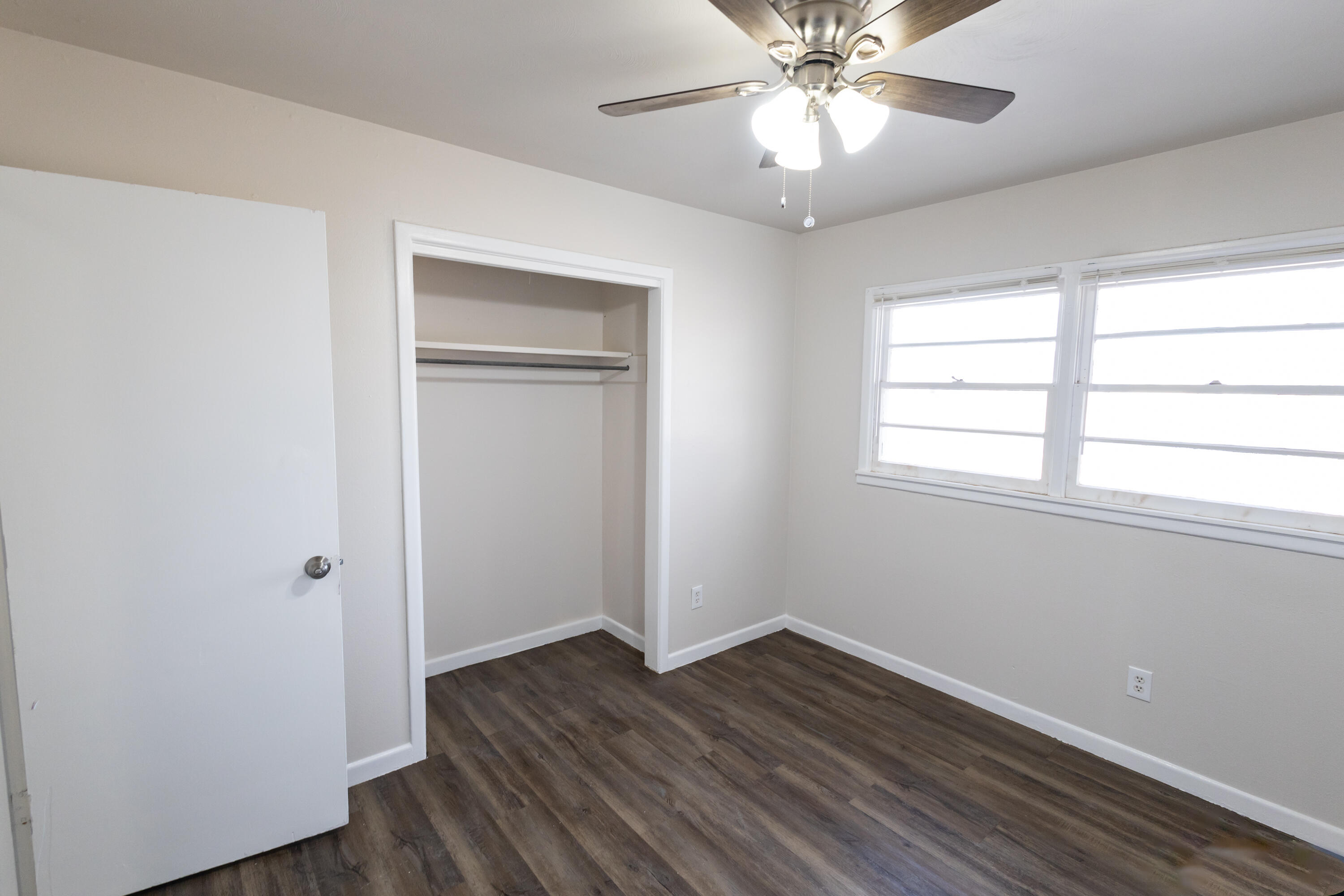 606 Bangor Avenue Lubbock, TX 79416 - Photo 18 of 26 a view of an empty room with wooden floor and a window