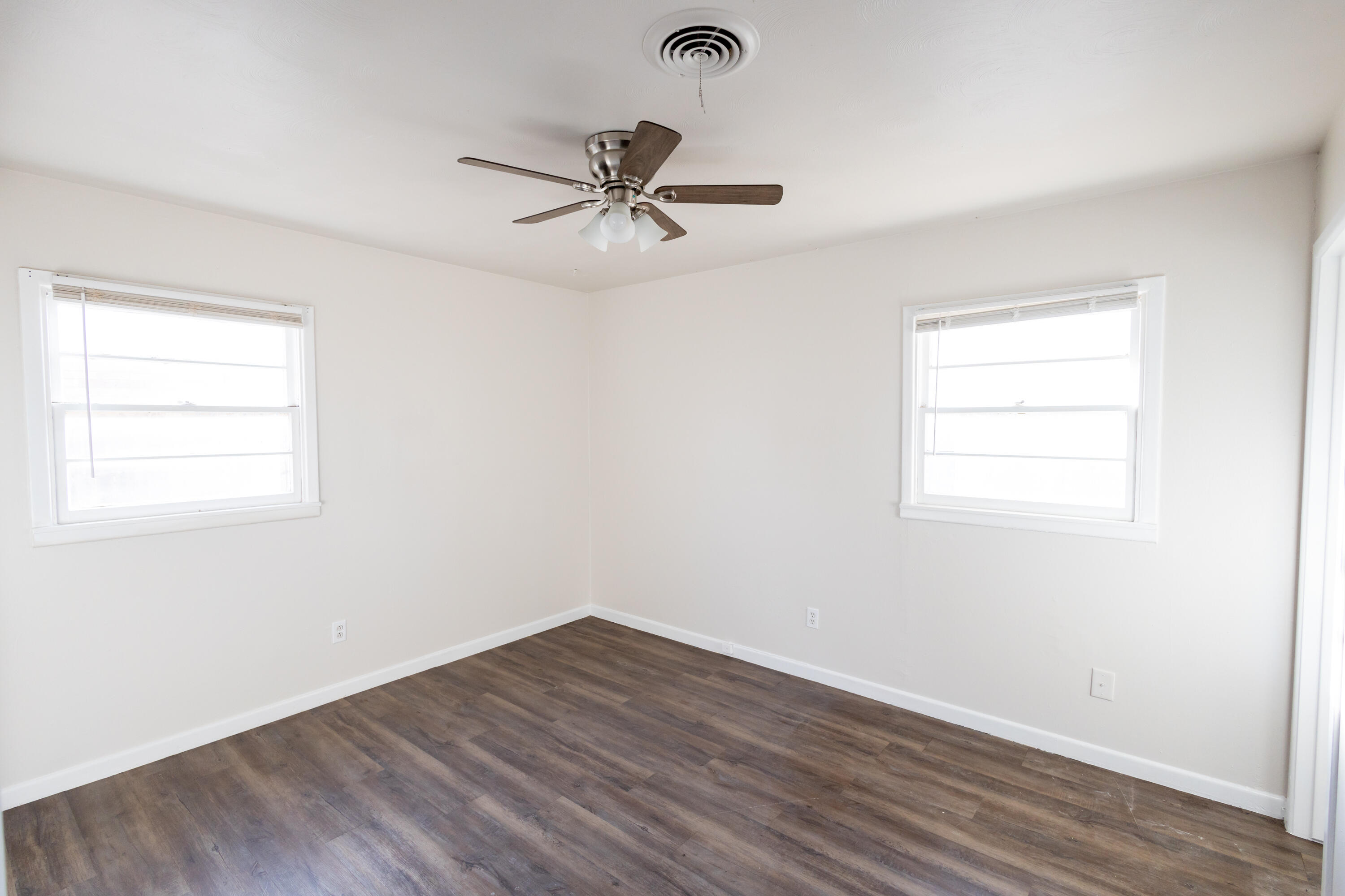 606 Bangor Avenue Lubbock, TX 79416 - Photo 20 of 26 an empty room with wooden floor closet and windows