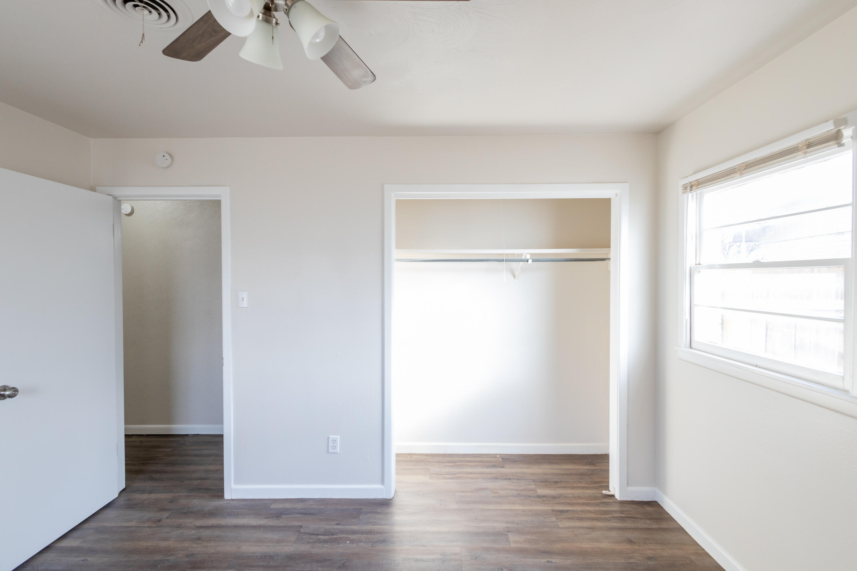 606 Bangor Avenue Lubbock, TX 79416 - Photo 21 of 26 a view of an empty room with wooden floor and a window