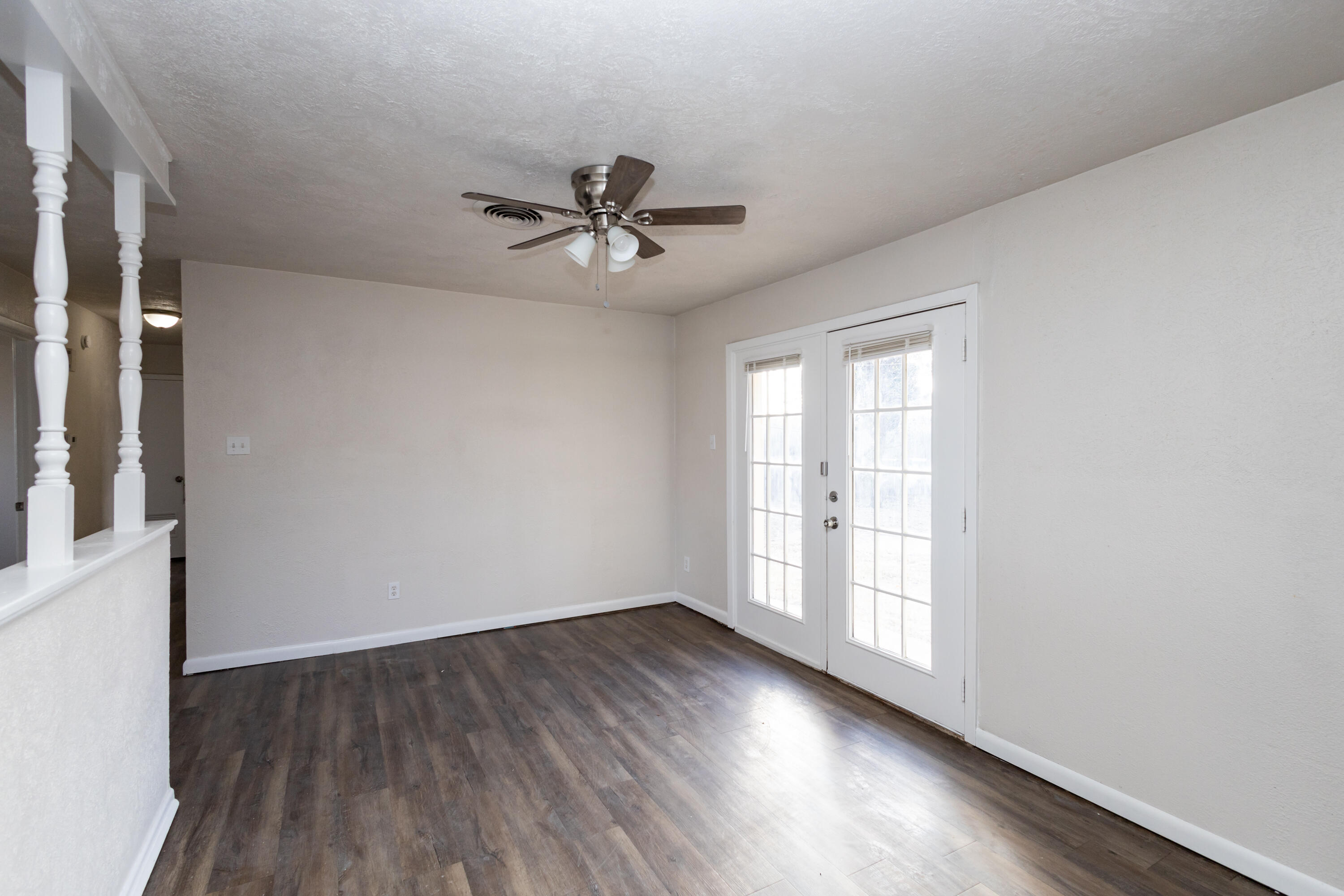 606 Bangor Avenue Lubbock, TX 79416 - Photo 10 of 26 a view of empty room with wooden floor and fan