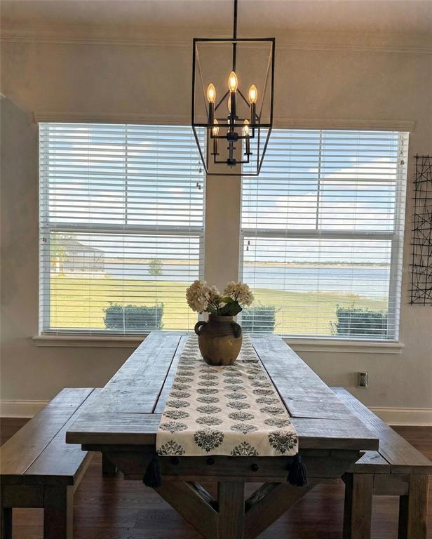 236 Caladium Avenue Lake Alfred, FL 33850 - Photo 14 of 33 a view of a dining room with furniture and wooden floor