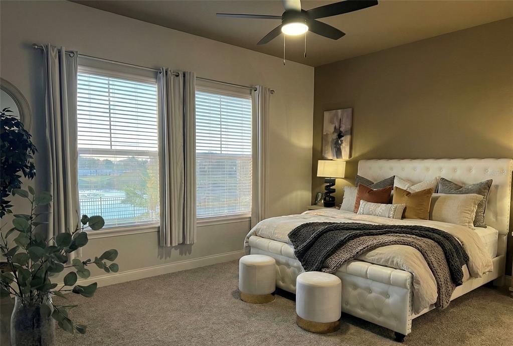 236 Caladium Avenue Lake Alfred, FL 33850 - Photo 17 of 33 a bedroom with a bed and large windows
