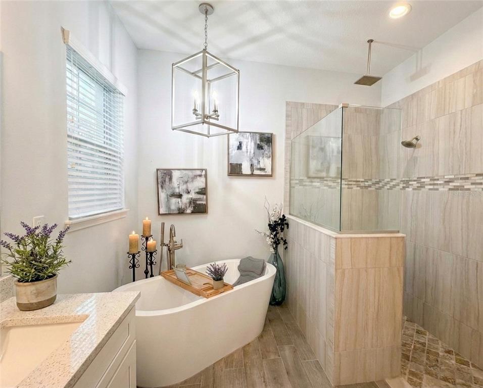 236 Caladium Avenue Lake Alfred, FL 33850 - Photo 18 of 33 a bath tub sitting in a bathroom next to a window