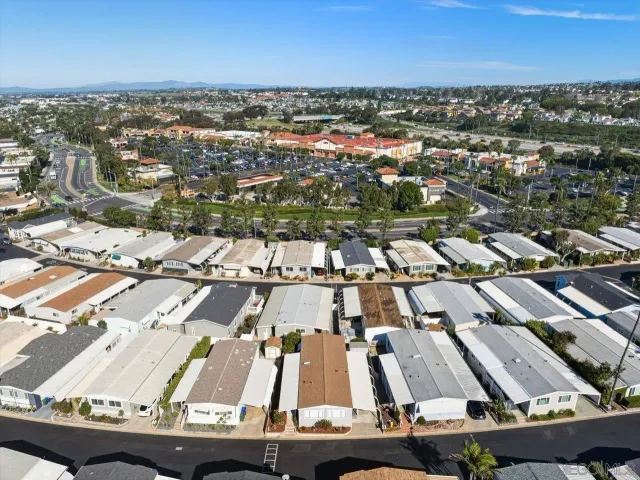 an aerial view of residential houses with city view