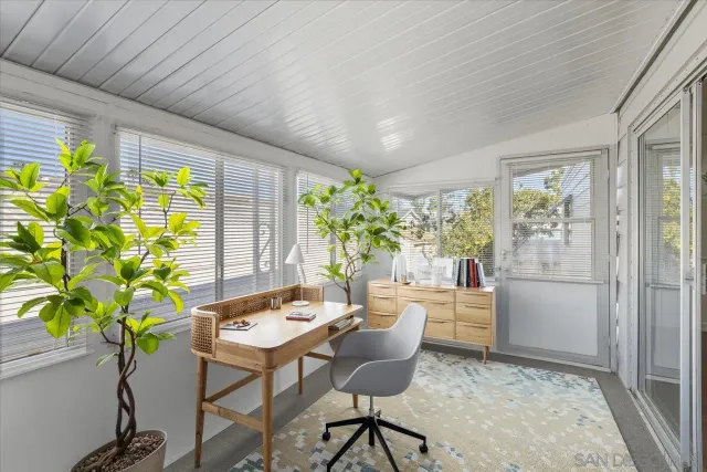 a kitchen with a table and chairs in front of a window