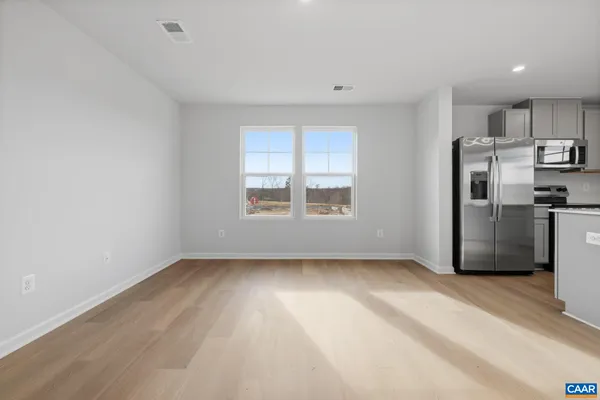 a view of a kitchen with a sink refrigerator and window