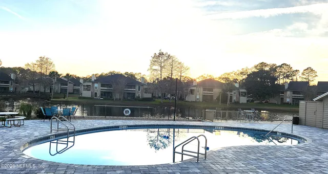 a view of a swimming pool with a table and chairs