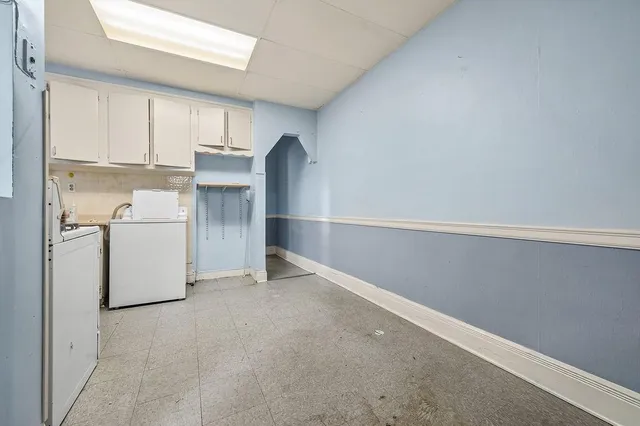 a kitchen with sink cabinets and white appliances