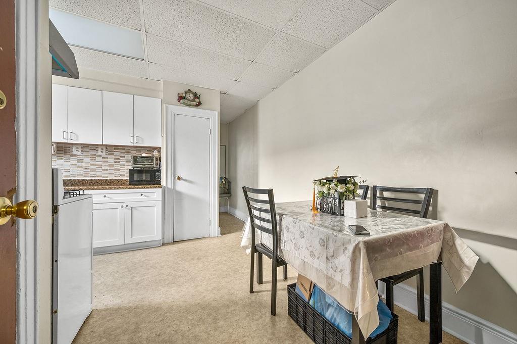 86 Quentin Road Brooklyn, NY 11223 - Photo 15 of 32 a dining room with furniture and window