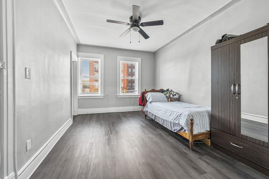 86 Quentin Road Brooklyn, NY 11223 - Photo 17 of 32 a spacious bedroom with a bed and a window