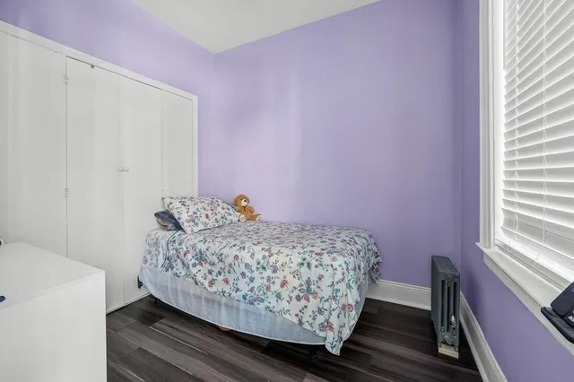 a bed room with a bed and a window