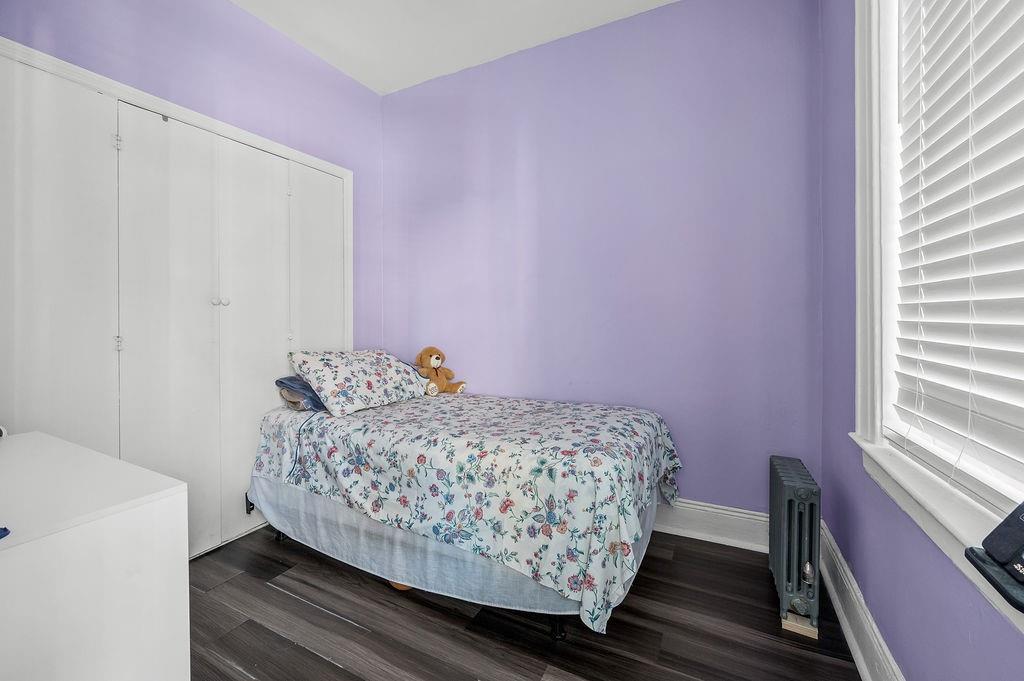 86 Quentin Road Brooklyn, NY 11223 - Photo 18 of 32 a bedroom with a bed and a window