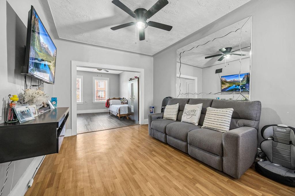 86 Quentin Road Brooklyn, NY 11223 - Photo 19 of 32 a living room with furniture and a flat screen tv