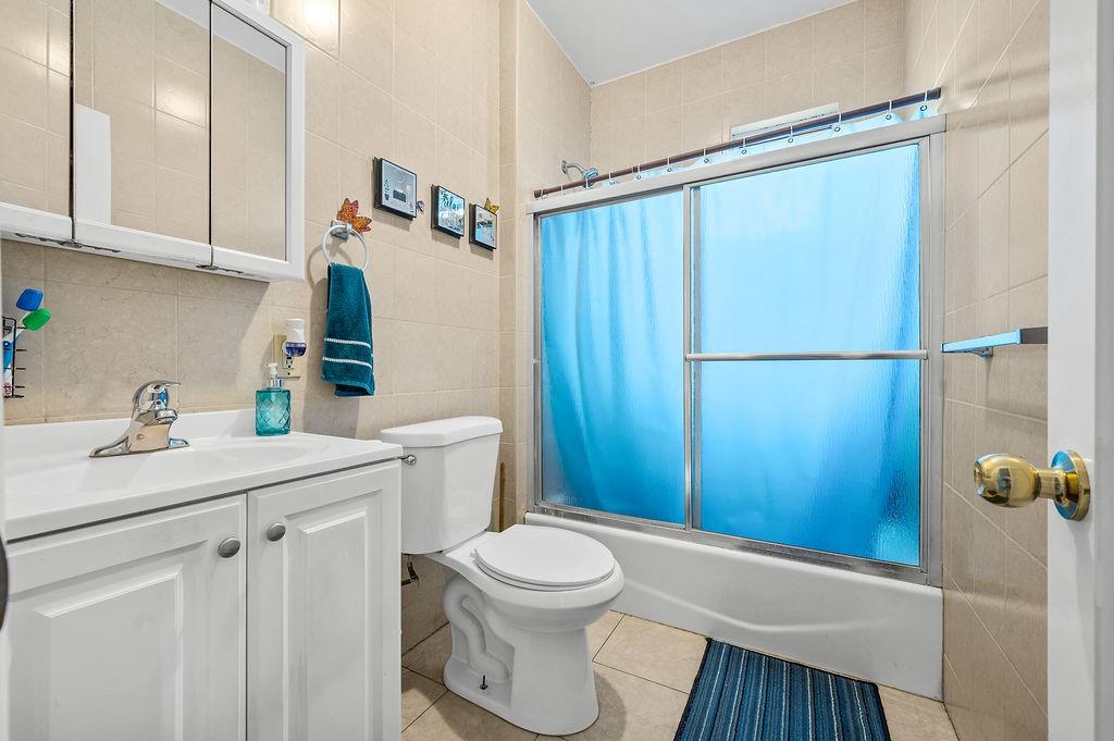 86 Quentin Road Brooklyn, NY 11223 - Photo 21 of 32 a bathroom with a sink a toilet and shower