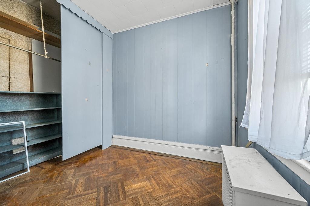 86 Quentin Road Brooklyn, NY 11223 - Photo 8 of 32 a view of empty room with empty racks