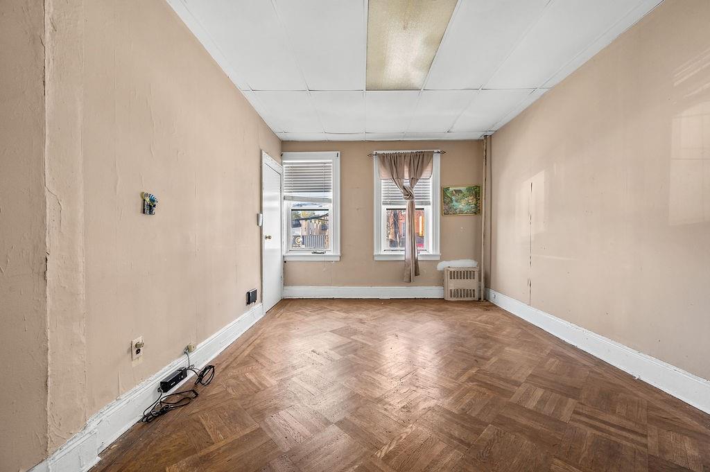 86 Quentin Road Brooklyn, NY 11223 - Photo 9 of 32 an empty room with windows