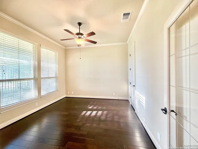wooden floor in an empty room with a window