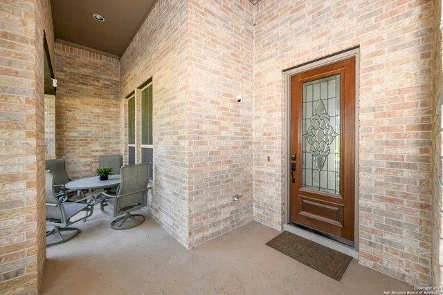 a view of a hallway with wooden floor and a potted plant