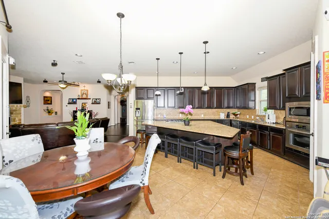 a living room with furniture a large window and flat screen tv