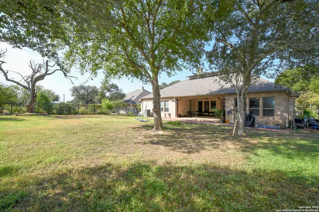 a yellow house with trees in front of it