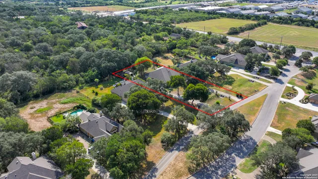 an aerial view of residential houses with outdoor space and swimming pool