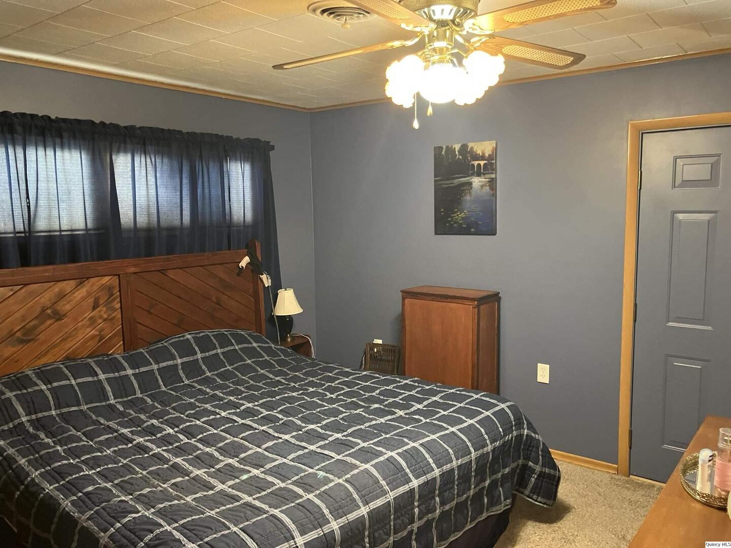 2524 Southbrook Road Quincy, IL 62305 - Photo 15 of 32 a bedroom with a bed and a chandelier