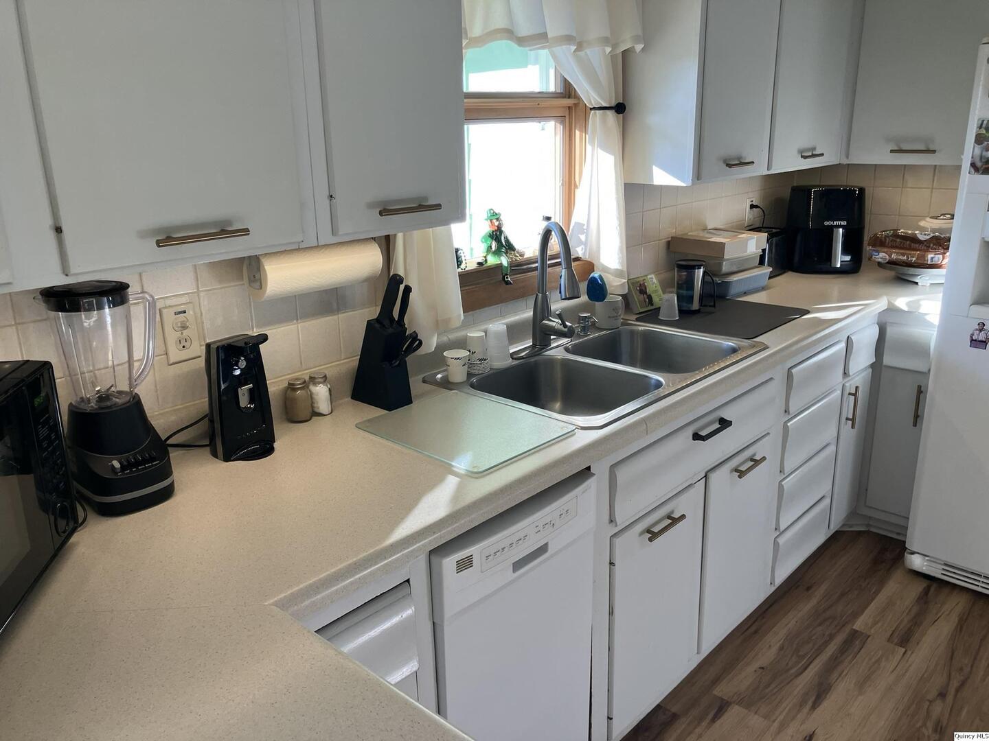 2524 Southbrook Road Quincy, IL 62305 - Photo 7 of 32 a kitchen with white cabinets and sink