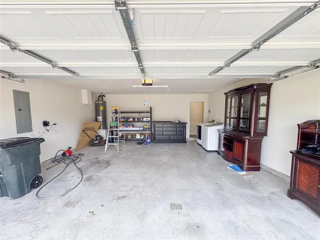 a view of an empty room with a fireplace and a window