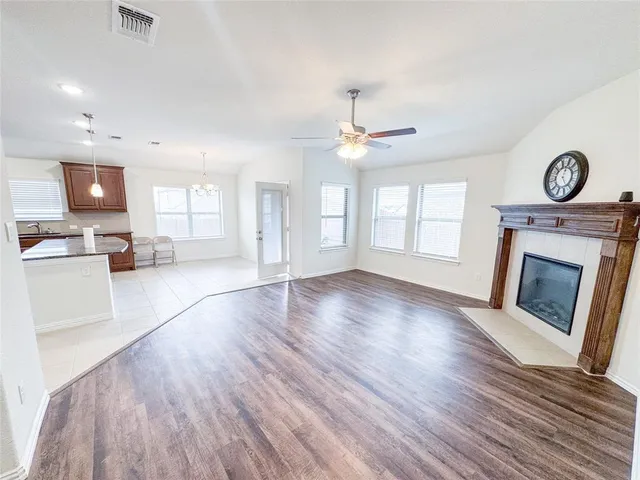 an open kitchen with white cabinets and stainless steel appliances