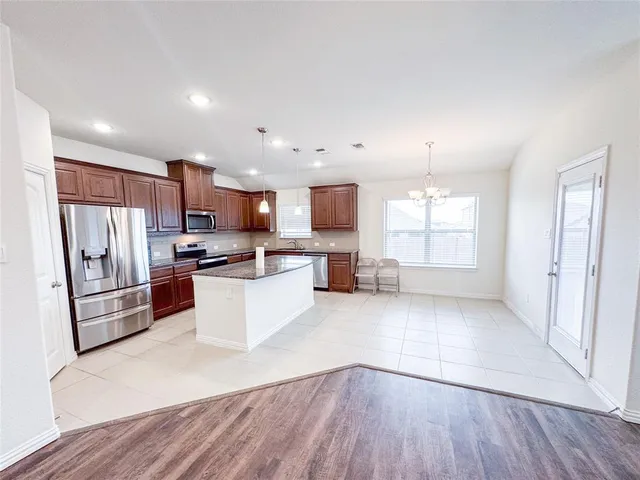 a large kitchen with stainless steel appliances lots of counter top space