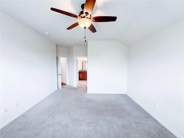 a white toilet sitting next to a white wall