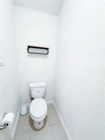 a large bathroom with a granite countertop sink a toilet and a large mirror