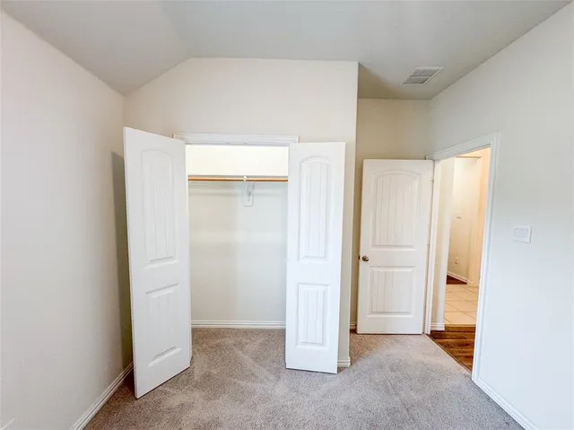 a bathroom with a granite countertop sink toilet a shower and a mirror