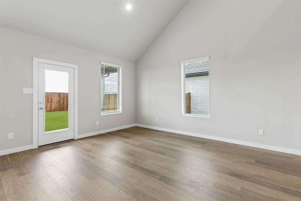 1121 Del Rio Drive Lavon, TX 75166 - Photo 11 of 32 a view of an empty room with wooden floor and a window