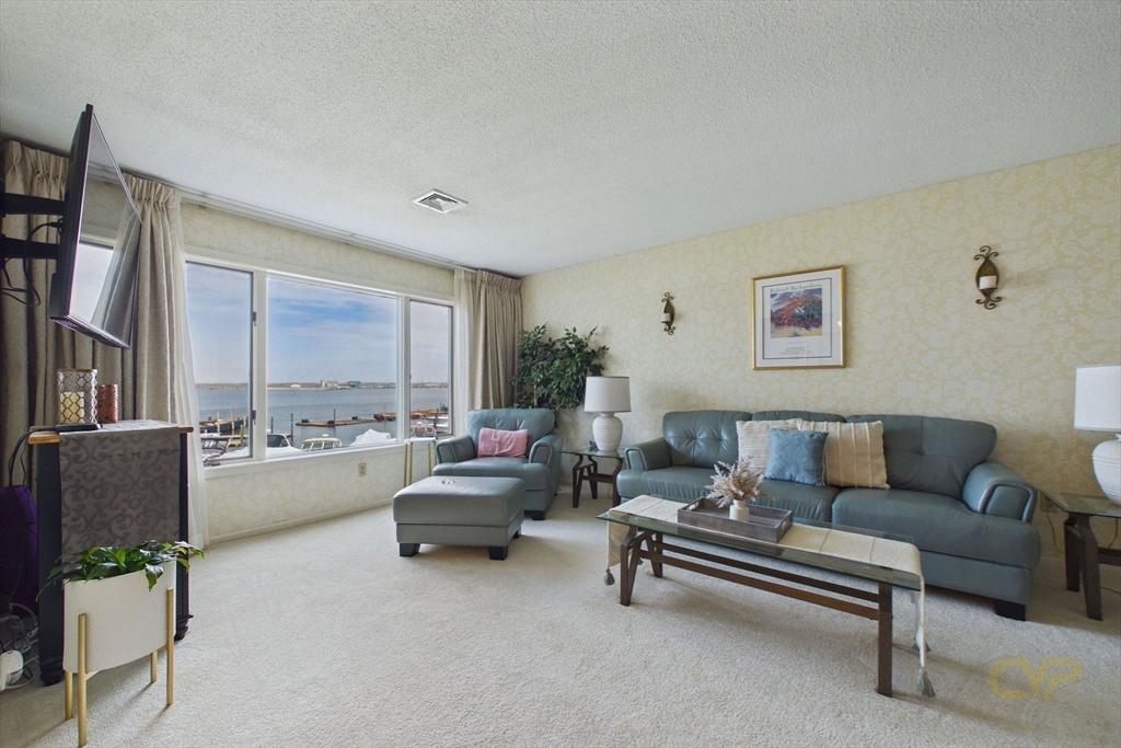 700 Shore Drive, Unit 509 Fall River, MA 02721 - Photo 7 of 25 a living room with furniture and a large window