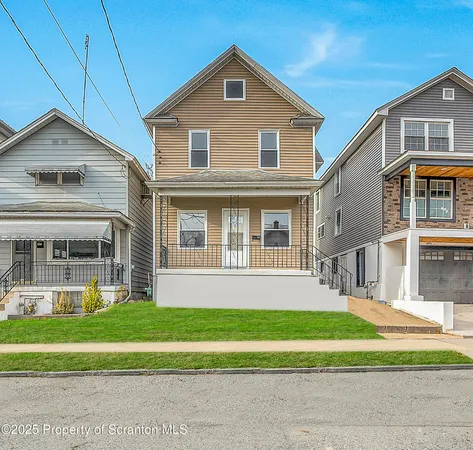 a front view of a house with a yard and porch