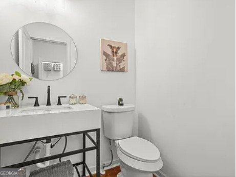 3925 Pineshore Circle Gainesville, GA 30501 - Photo 7 of 18 a bathroom with a toilet a sink and mirror